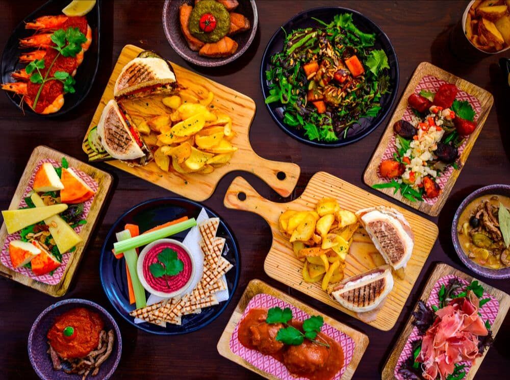 Selection of pregos, hummus, salad.