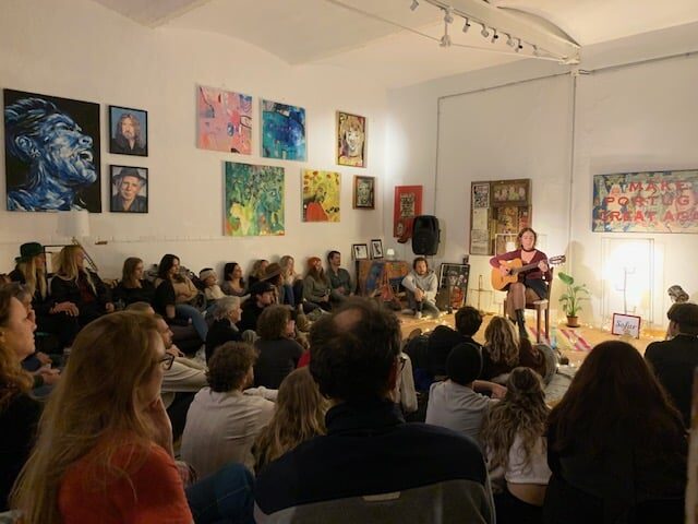 Crowd of people watching an intimate concert.