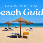 Sun lounges and a straw umbrella on white sand at Meia Praia Beach in Lagos Portugal